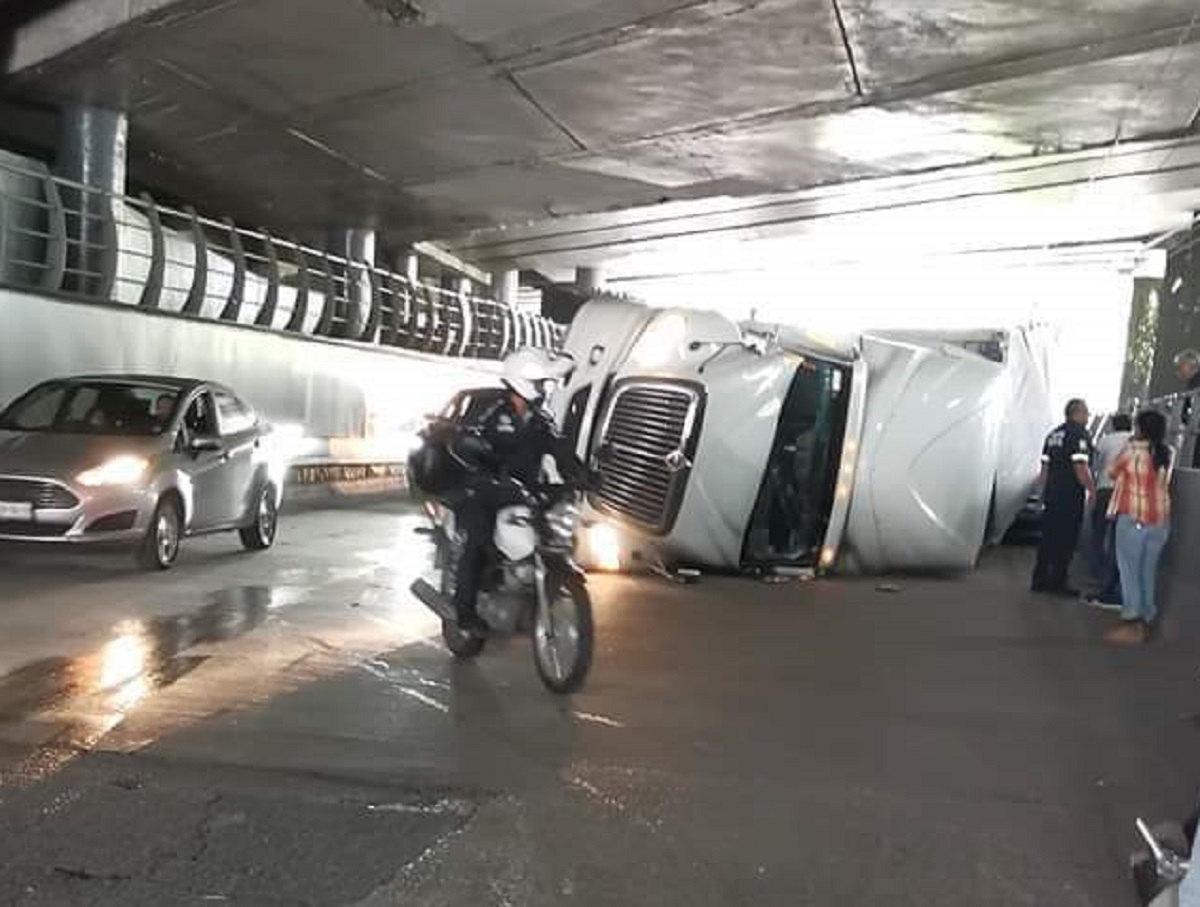 Tráiler vuelca en su costado debajo de un puente, en Ciudad Satélite